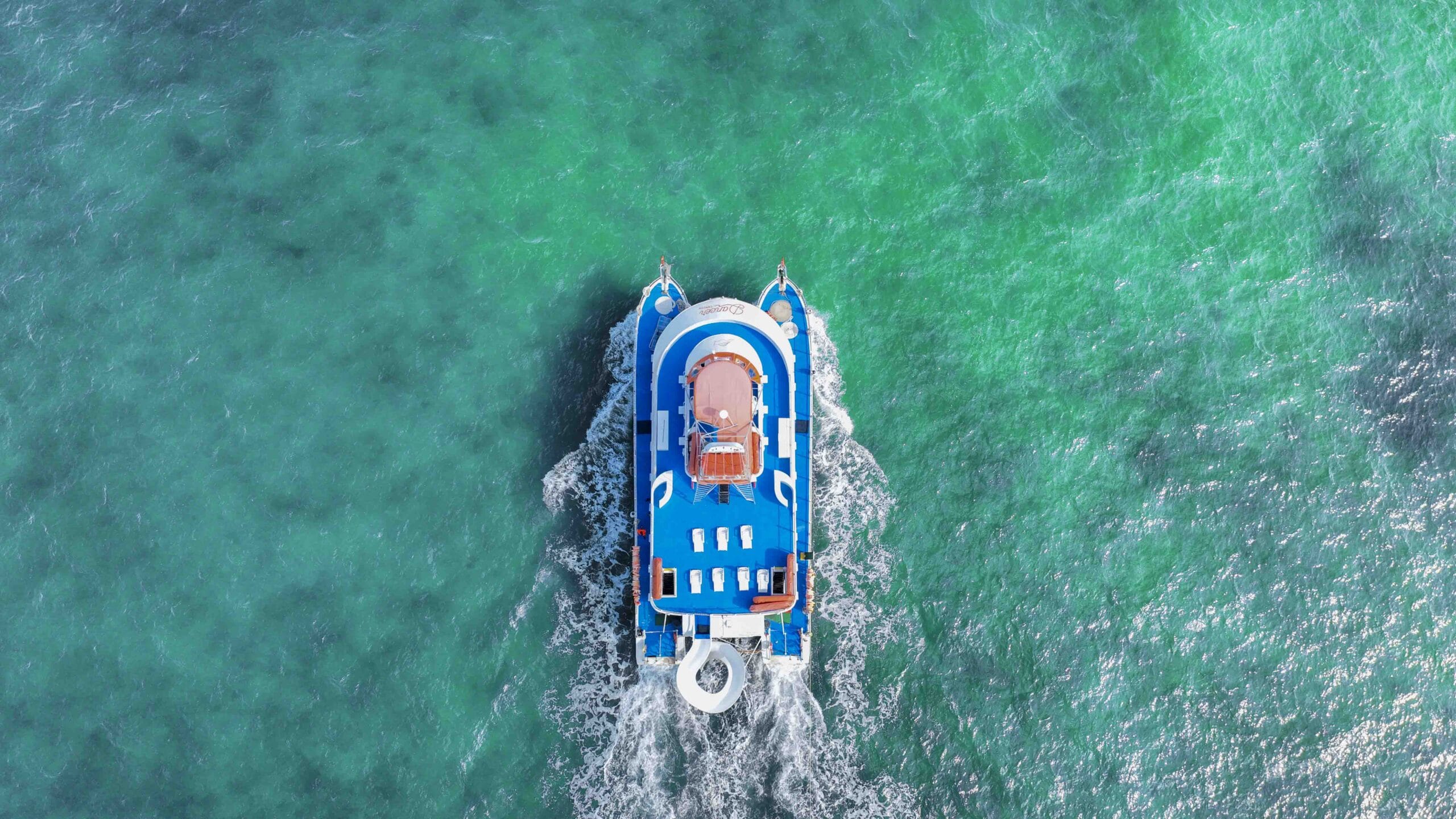 Aerial view of Dancer Catamaran 77 Cancún sailing in turquoise Caribbean water